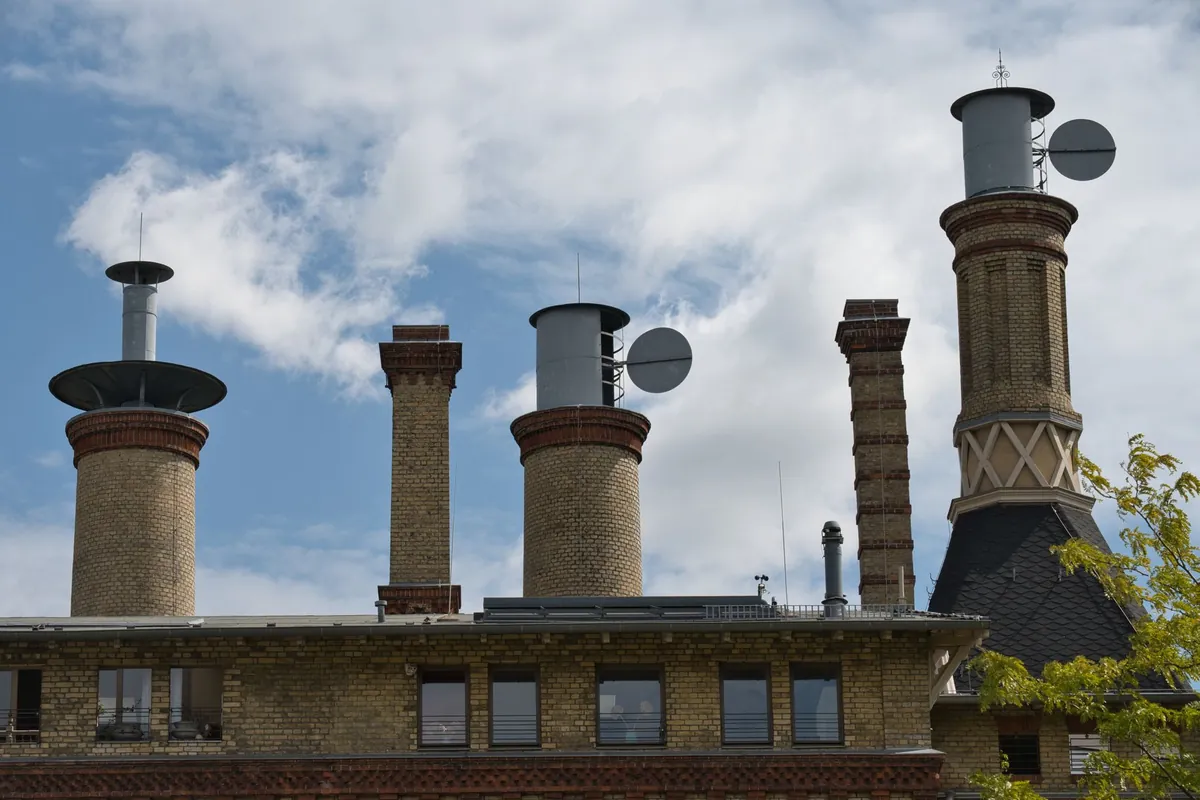 A brick chimney stack rising above a tiled roof