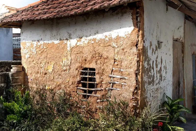 Cracked and displaced roof tiles on an older pitched roof